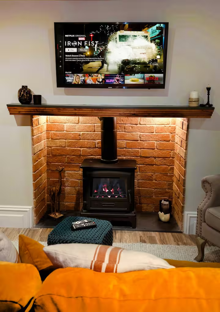 Rittson Cottage cosy living room with gas fireplace and armchair, holiday cottage near the Lake District